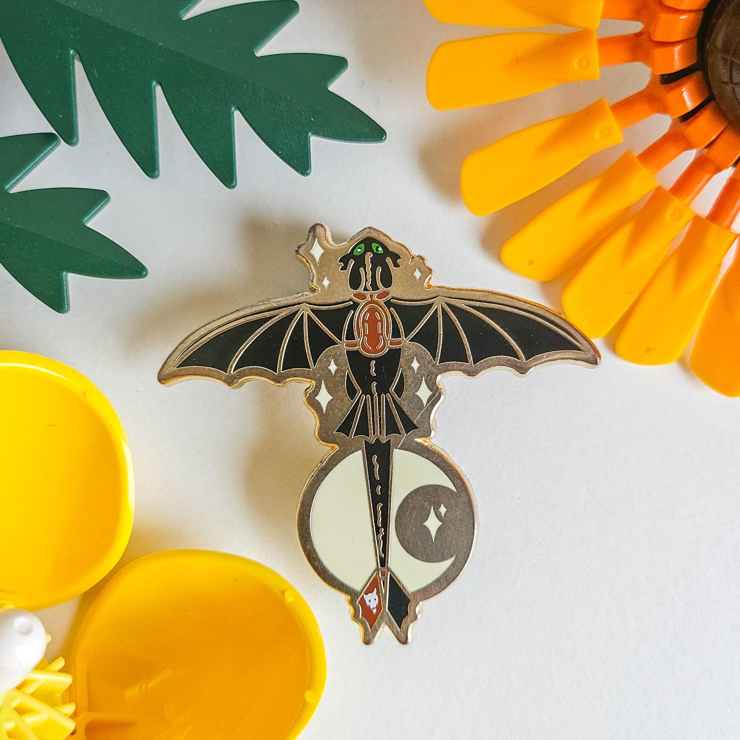 Toothless enamel pin